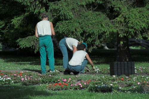 Trained gardener using safe working methods in Fulwell